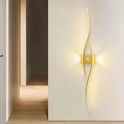 LifeHub Shade gold wavy wall lamp mounted on white wall with warm glow